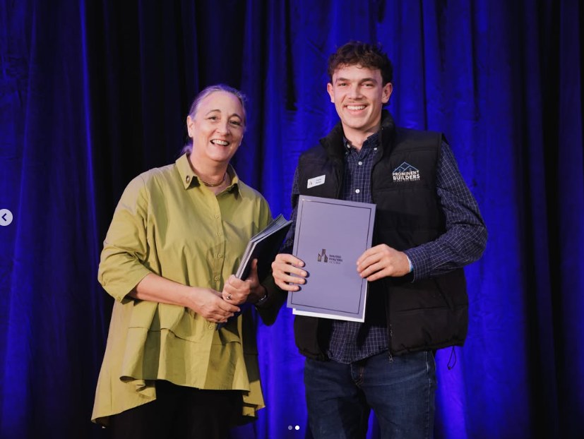 Lachy, Prominent Builders apprentice carpenter, on stage receiving a Certificate of Excellence at the Master Builders Victoria Apprentice Awards