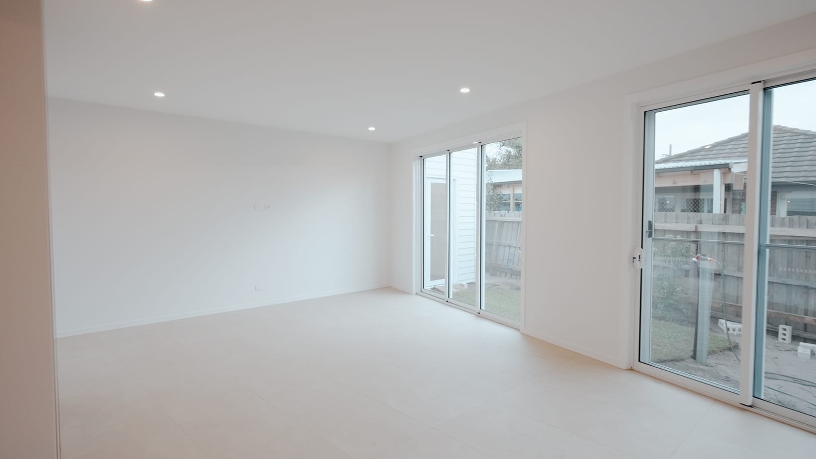 Living area with sliding doors opening to the rear yard