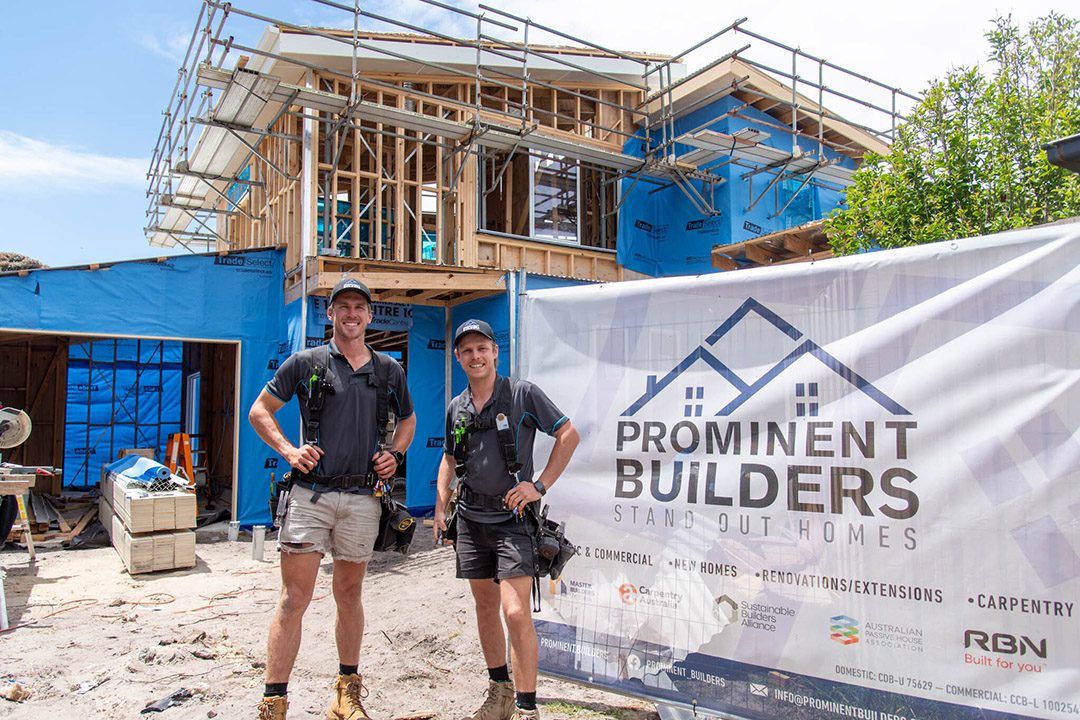 Prominent Builders team on site in front of a timber-framed building