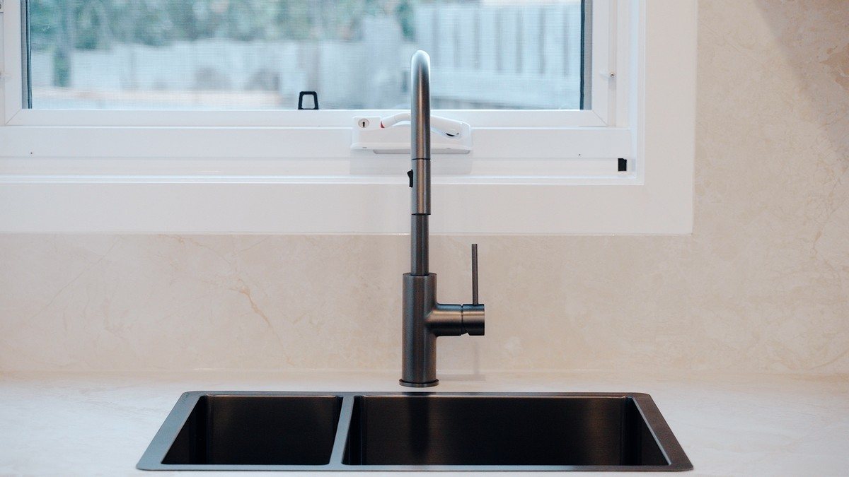 Renovated kitchen with a black undermount sink and gooseneck mixer